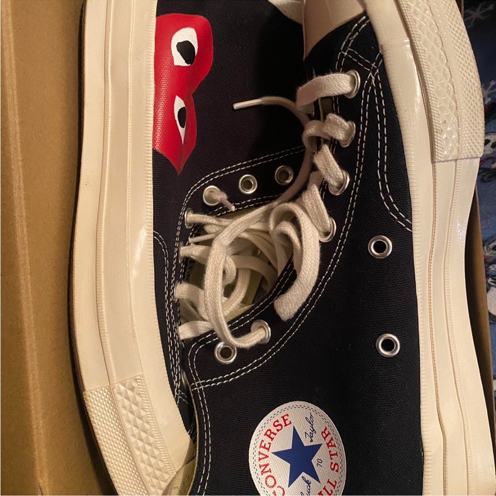 Black and red Comme des Garçons Play x Converse black high tops.